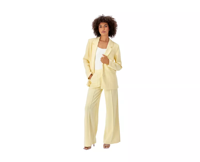 Mujer con traje color crema en una sesión de fotografía de moda con modelo en vivo