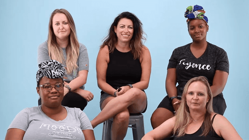 Group of Diverse Women Posing Against Blue Background