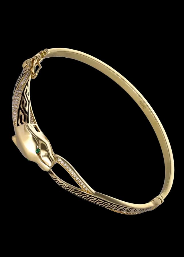 Pulsera rígida con cabeza de pantera en oro, ojos verdes, diamantes y esmalte